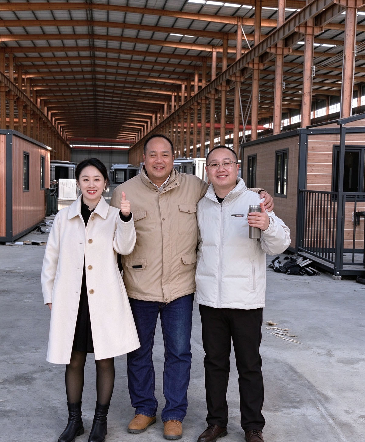 Singaporean partners visited the factory for inspection! They appreciated the wood‑grain prefabricated light steel residence on site.